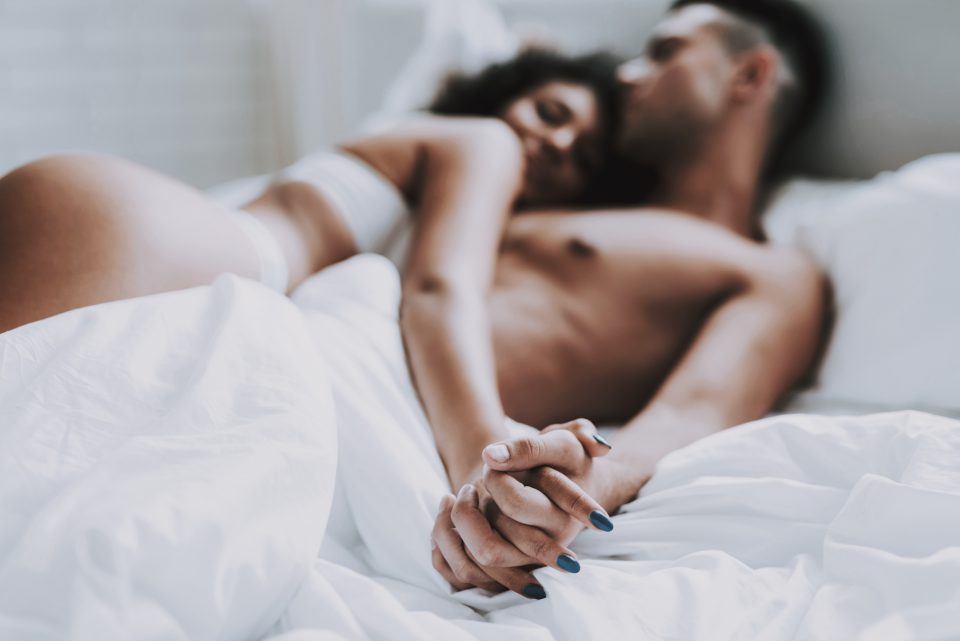 Young Beautiful Couple In Underwear Lying On Bed